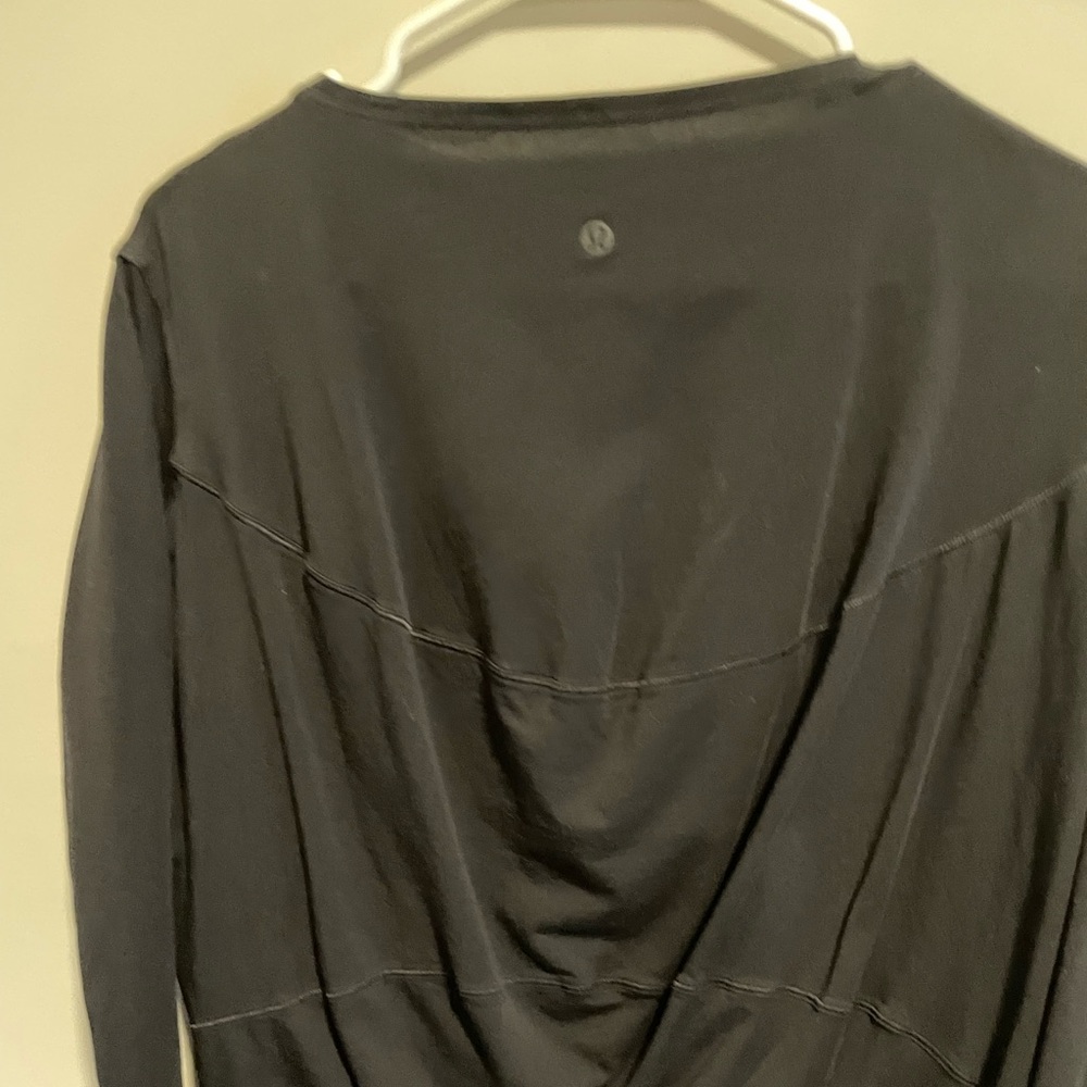 Lululemon black long sleeve.  The tags were cut out. But the emblem is on back.
